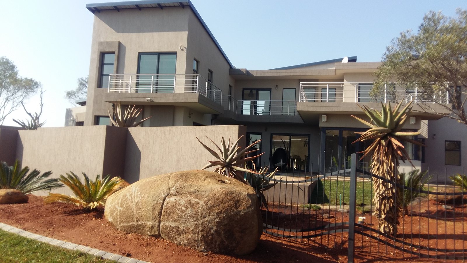 Completed coating project on a landscaped modern home